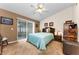 Comfortable main bedroom with sliding glass doors to a patio and neutral decor at 8060 Timberlake Ave, Spring Hill, FL 34606