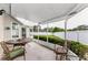 Relaxing screened patio featuring a dining table, chairs, and a view of the backyard at 8060 Timberlake Ave, Spring Hill, FL 34606