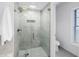 Modern bathroom highlighting a glass shower with rainfall shower head at 8127 Siquita Ne Dr, St Petersburg, FL 33702