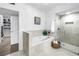 Bright bathroom featuring a tub, glass shower, and entry to a walk in closet at 8127 Siquita Ne Dr, St Petersburg, FL 33702
