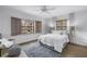 Inviting bedroom filled with natural light showcasing wood flooring and window shutters at 8127 Siquita Ne Dr, St Petersburg, FL 33702