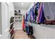 A walk-in closet with hanging clothes and shoe shelves at 8127 Siquita Ne Dr, St Petersburg, FL 33702