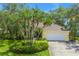 Charming home exterior featuring a well-maintained lawn, beautiful landscaping, and a welcoming facade with a two-car garage at 8127 Siquita Ne Dr, St Petersburg, FL 33702