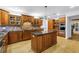 Spacious kitchen featuring custom cabinets, a large island, stone countertops, and built-in stainless steel appliances at 8127 Siquita Ne Dr, St Petersburg, FL 33702