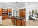 Kitchen with a large island, custom wood cabinets, granite counters, and modern stainless steel appliances at 8127 Siquita Ne Dr, St Petersburg, FL 33702
