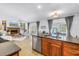 Bright kitchen with an island, stainless appliances, granite countertops, and bar seating that opens to the living room at 8127 Siquita Ne Dr, St Petersburg, FL 33702