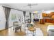 Open-concept living room featuring stylish furniture, modern decor, and multiple french door access to pool at 8127 Siquita Ne Dr, St Petersburg, FL 33702