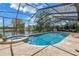 A screened in pool and jacuzzi with a view of the lake at 8127 Siquita Ne Dr, St Petersburg, FL 33702