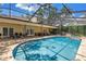 Gorgeous screened-in pool area with ample patio space and multiple seating arrangements at 8127 Siquita Ne Dr, St Petersburg, FL 33702