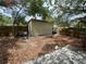 Backyard shed surrounded by fence and vegetation at 834 Grand Central St, Clearwater, FL 33756