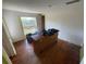 Bedroom features a window and wood floors, natural light, and some discarded items at 834 Grand Central St, Clearwater, FL 33756