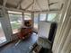 Sunroom with white windows, wood floors, and a dresser at 834 Grand Central St, Clearwater, FL 33756