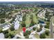 Aerial view of property in community with lakes, golf course, and mature tree coverage at 860 Maclaren N Dr # A, Palm Harbor, FL 34684
