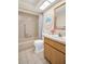 A charming bathroom with a bathtub, shower, vanity, and decorative ocean-themed artwork at 860 Maclaren N Dr # A, Palm Harbor, FL 34684