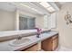 Well-lit bathroom featuring a double sink vanity, a shower, and decorative starfish at 860 Maclaren N Dr # A, Palm Harbor, FL 34684