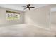 Inviting bedroom featuring a ceiling fan and natural light from the large window at 860 Maclaren N Dr # A, Palm Harbor, FL 34684