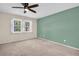 Spacious bedroom with large windows and neutral carpet, offering plenty of natural light and comfort at 860 Maclaren N Dr # A, Palm Harbor, FL 34684