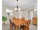 Dining room featuring chandelier lighting and a large wooden table with seating for four at 860 Maclaren N Dr # A, Palm Harbor, FL 34684