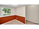Cozy eat-in kitchen featuring chair railing, tiled floors, and a large window with bright natural lighting at 860 Maclaren N Dr # A, Palm Harbor, FL 34684