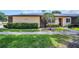 Inviting single story home with meticulously maintained landscaping, sidewalk, and a well-kept lawn at 860 Maclaren N Dr # A, Palm Harbor, FL 34684
