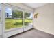 Enclosed Florida room showcasing views of the surrounding yard and green space at 860 Maclaren N Dr # A, Palm Harbor, FL 34684
