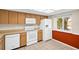 Well-lit kitchen with white appliances and ample cabinet space; window allows natural light at 860 Maclaren N Dr # A, Palm Harbor, FL 34684