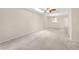 Spacious living room with a ceiling fan, skylight and neutral carpet flooring at 860 Maclaren N Dr # A, Palm Harbor, FL 34684