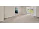 Open living room featuring a sliding glass door leading to an outdoor area at 860 Maclaren N Dr # A, Palm Harbor, FL 34684