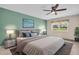 Serene main bedroom with neutral gray furniture, a leafy plant, and a ceiling fan at 860 Maclaren N Dr # A, Palm Harbor, FL 34684