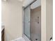 Neutral bathroom shower with textured tilework, sliding glass door, and safety bar at 860 Maclaren N Dr # A, Palm Harbor, FL 34684