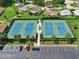 Aerial view of well-maintained tennis courts surrounded by lush landscaping and convenient parking at 860 Maclaren N Dr # A, Palm Harbor, FL 34684