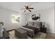 Comfortable bedroom with a large window, neutral colors, and a ceiling fan creating a calming retreat at 9831 83Rd Way, Seminole, FL 33777