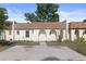 Charming townhouse featuring an arched entryway, fresh landscaping, and a spacious driveway at 9831 83Rd Way, Seminole, FL 33777