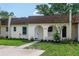Inviting single-story home featuring an arched entryway, manicured lawn, and neutral paint scheme at 9831 83Rd Way, Seminole, FL 33777
