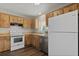Spacious kitchen with wood cabinets, white appliances, and ample counter space, perfect for cooking and entertaining at 9831 83Rd Way, Seminole, FL 33777