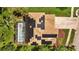 Aerial view of the home featuring solar panels on roof and screened pool in the backyard at 10646 Cory Lake Dr, Tampa, FL 33647