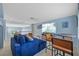 Upstairs bonus room featuring a large sofa, tv, and bar seating at 10646 Cory Lake Dr, Tampa, FL 33647