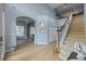 Open foyer with staircase and archway, showcasing the home's airy layout at 10646 Cory Lake Dr, Tampa, FL 33647