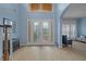 Bright foyer featuring hardwood floors and ornate glass front doors at 10646 Cory Lake Dr, Tampa, FL 33647