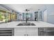 Open concept kitchen with island, stainless steel appliances, and stylish decor at 10646 Cory Lake Dr, Tampa, FL 33647