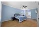 Tranquil main bedroom with blue walls, ceiling fan, and access to the ensuite bathroom at 10646 Cory Lake Dr, Tampa, FL 33647