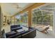 Relaxing screened-in patio featuring comfortable seating, ceiling fans, and views of the pool and lush backyard at 10646 Cory Lake Dr, Tampa, FL 33647