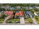 Aerial view of the home, showcasing a red tile roof, brick driveway, and mature landscaping at 10724 Cory Lake Dr, Tampa, FL 33647