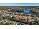 Aerial view showcasing the community and property with a screened pool, lake views, and mature landscaping at 10724 Cory Lake Dr, Tampa, FL 33647