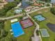 An aerial view of community sports facilities, including tennis and basketball courts and a swimming pool with clubhouse at 10724 Cory Lake Dr, Tampa, FL 33647