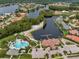 Aerial view of community amenities including a beach, pool, clubhouse, and lake at 10724 Cory Lake Dr, Tampa, FL 33647