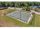Aerial view of a community basketball court surrounded by lush greenery and parking spots at 10724 Cory Lake Dr, Tampa, FL 33647