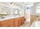 Bright bathroom with double vanity, large mirror, recessed lighting, and tile flooring at 10724 Cory Lake Dr, Tampa, FL 33647