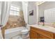 Cozy bathroom with tile flooring, shower and tub combo, and granite vanity at 10724 Cory Lake Dr, Tampa, FL 33647