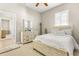 Bright bedroom with crisp white bedding, wood flooring and a door to the hall at 10724 Cory Lake Dr, Tampa, FL 33647